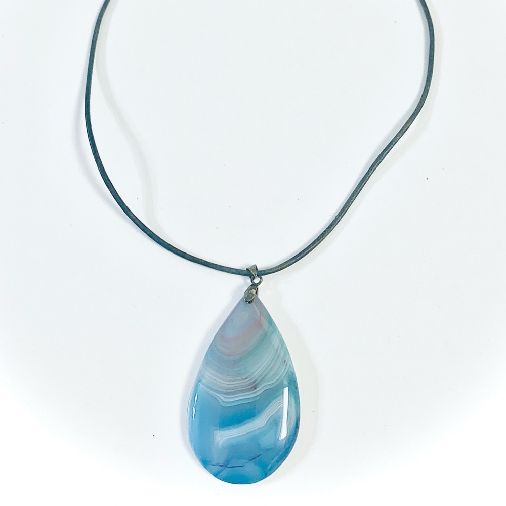Blue white purple tear drop agate pendant on blue stressed leather necklace.